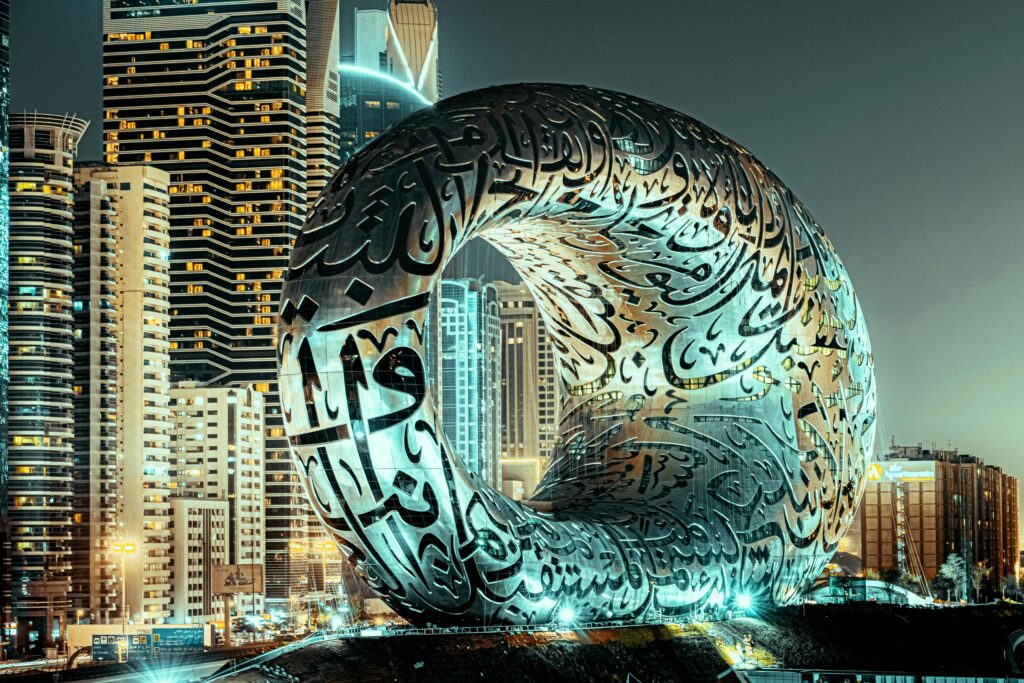 Stunning view of Dubai's Museum of the Future amidst city skyscrapers at night.